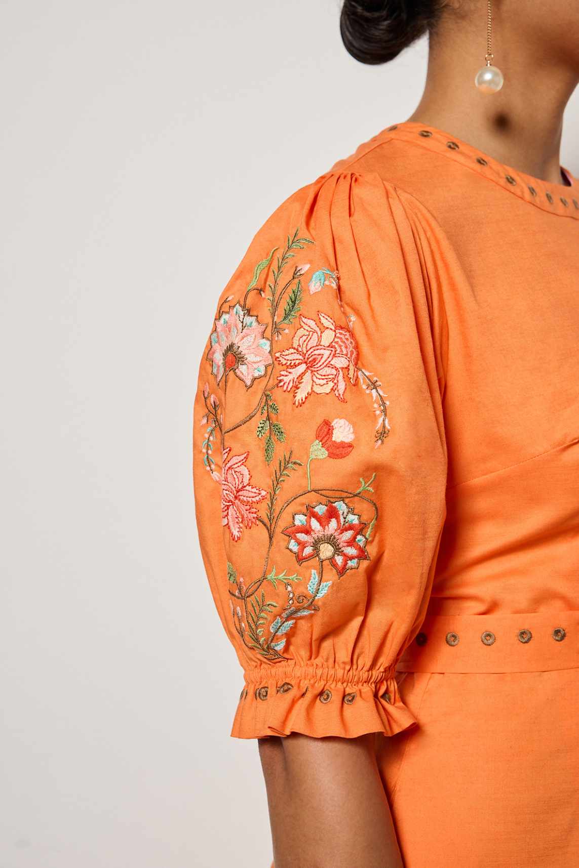 Detail shot of the blooming  floral embroidery that can be found  on Fanm Mon's Pintada Dress on both the sleeves and hemline.