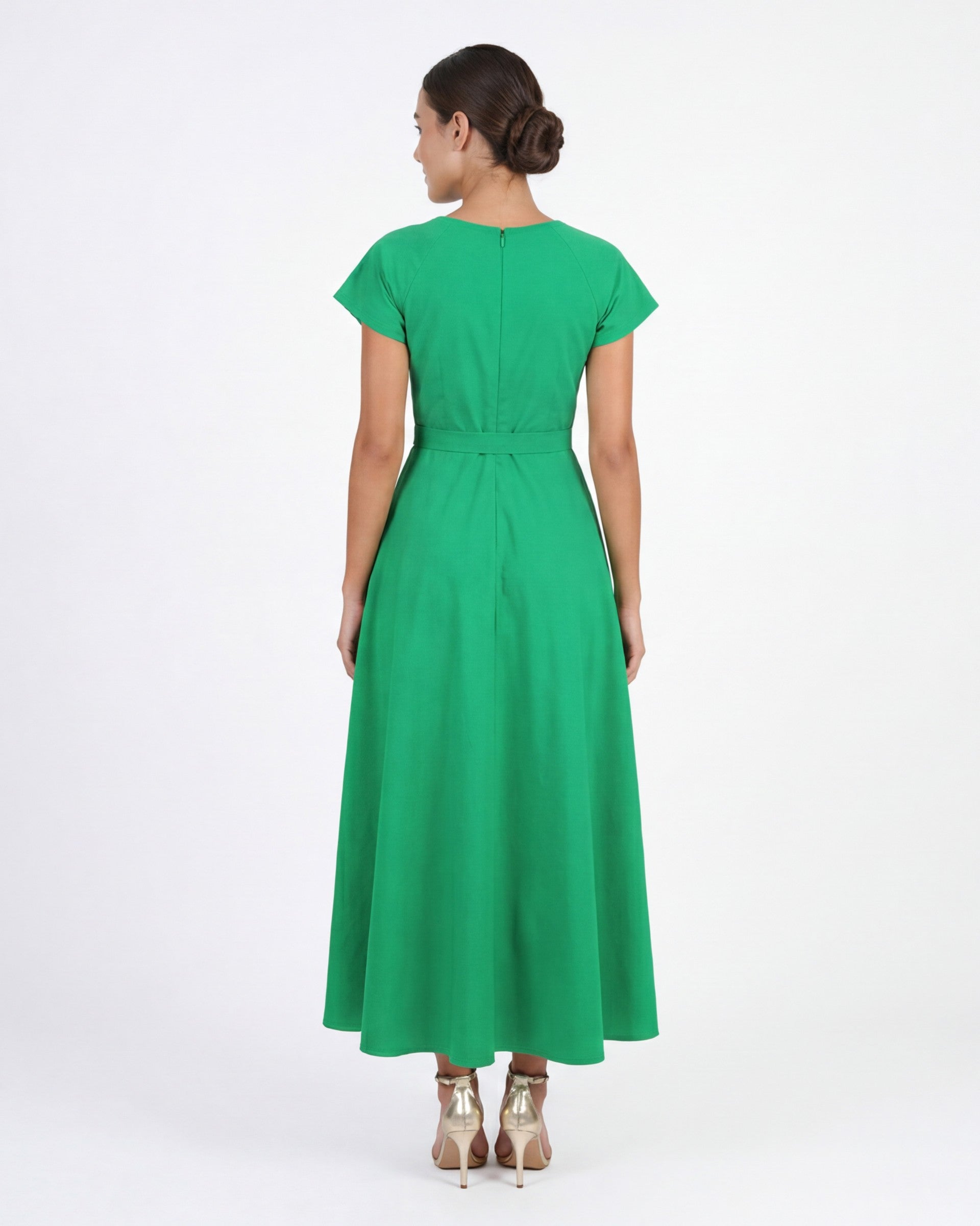 Model wearing the Fanm Mon Ritaj Dress with botanical wildflower embroidery, cap sleeves, adjustable waist tie, and elegant full-length skirt in back view against a neutral studio background.