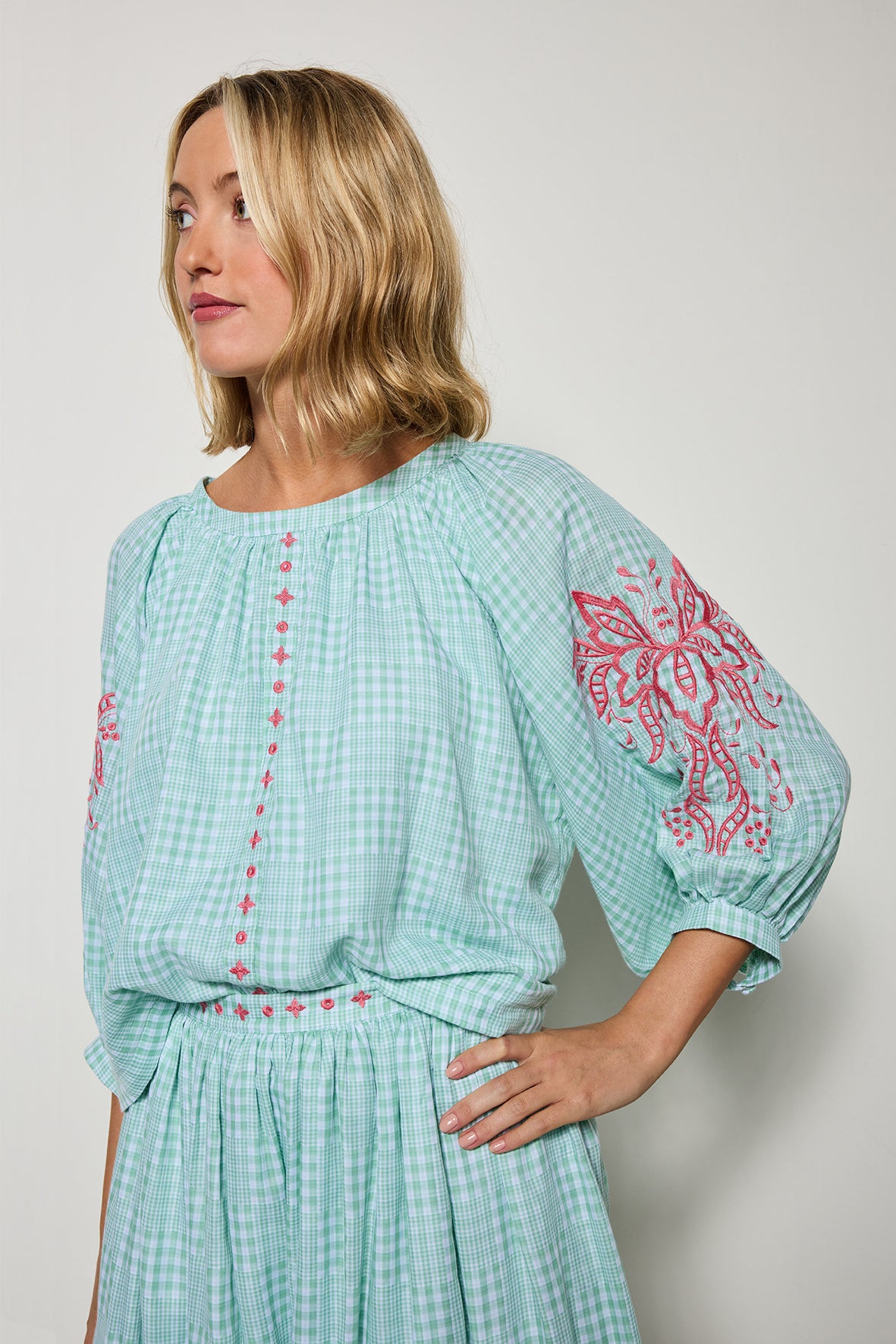 Model wearing Fanm Mon Tablas Set, detail shot of long sleeve top with embroidery details on white background