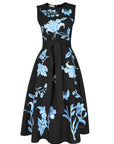 Fanm Mon Gera Dress in black featuring blue floral and botanical embroidery, embroidered butterflies, a sleeveless bodice, and self-tie belt.