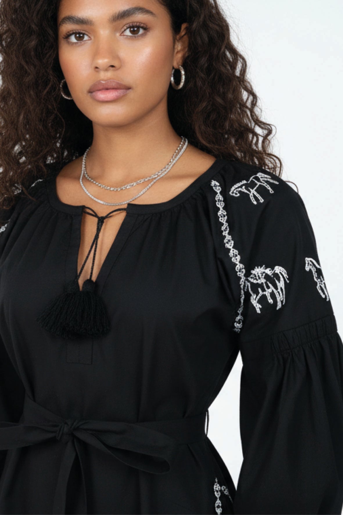 Close-up of the Fanm Mon Handan Dress highlighting the gathered neckline, tie-front keyhole, equestrian-inspired embroidery, and self-tie waist.