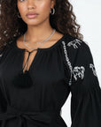 Close-up of the Fanm Mon Handan Dress highlighting the gathered neckline, tie-front keyhole, equestrian-inspired embroidery, and self-tie waist.