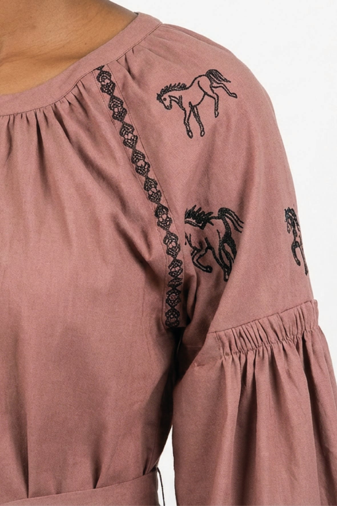 Close-up of the Fanm Mon Hayal Dress highlighting horse embroidery, contrast embroidered detailing, and gathered sleeve.