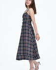 SIDE VIEW OF THE HURIYE DRESS IN NAVY TARTAN TWEED