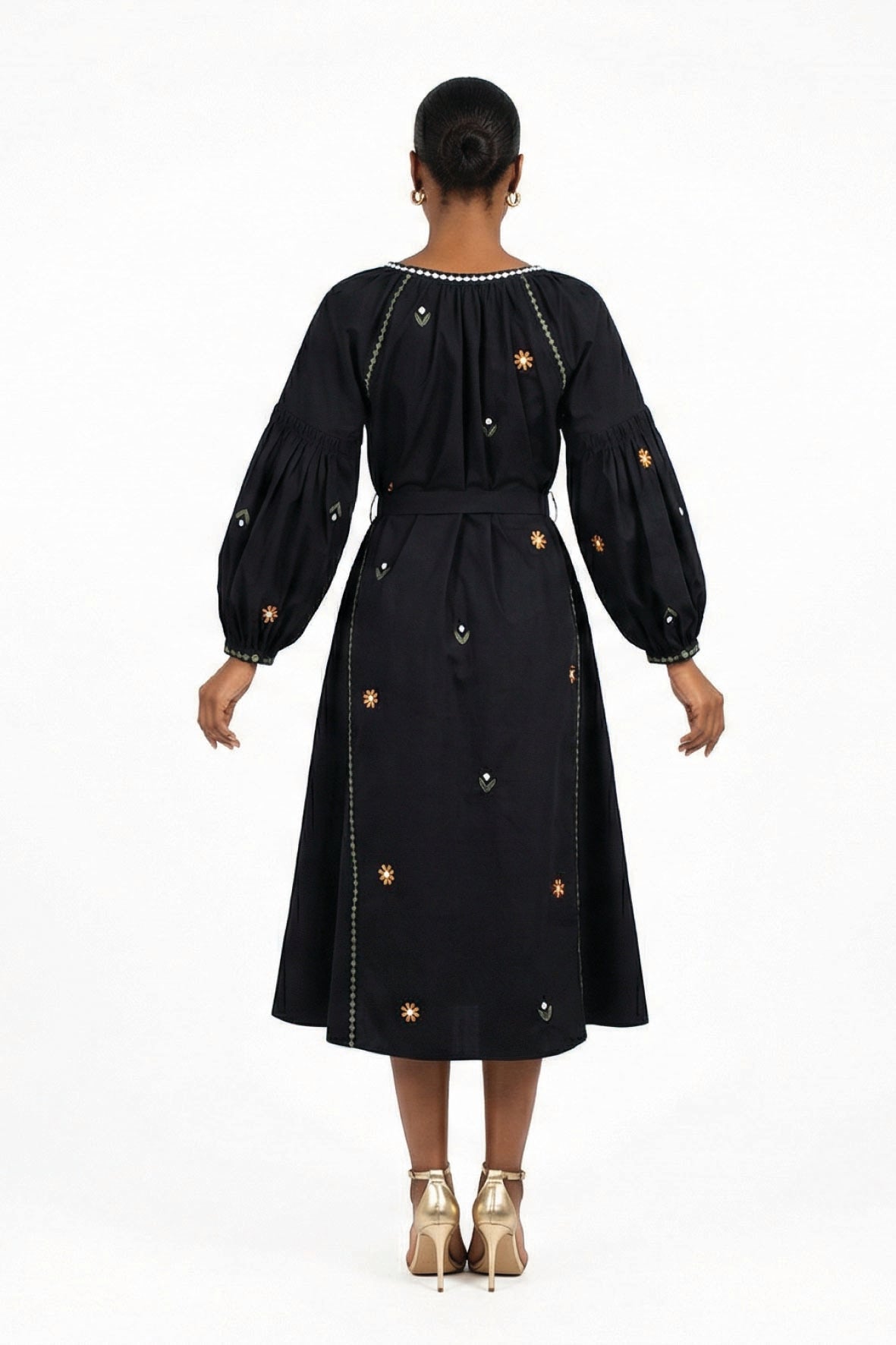 Back view of the Fanm Mon Lavina Dress featuring floral embroidery, contrast embroidered detailing, voluminous sleeves, and a self-tie waist.