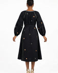Back view of the Fanm Mon Lavina Dress featuring floral embroidery, contrast embroidered detailing, voluminous sleeves, and a self-tie waist.