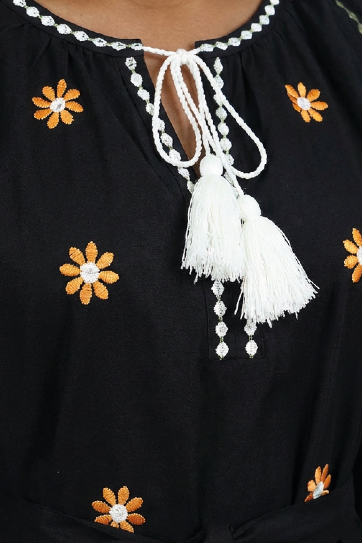 Close-up of the Fanm Mon Lavina Dress highlighting floral embroidery, contrast neckline detailing, and white tassel ties.