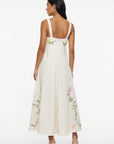 Back view of the Fanm Mon Leyla Dress showcasing embroidered shoulder straps, concealed back zipper, empire waist, and floral embroidery extending around the hem.