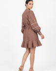 Fanm Mon Mel Dress back view featuring voluminous embroidered sleeves, a self-tie waist and ruffle hem.