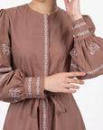 Fanm Mon Mel Dress detail featuring embroidered horse motifs, decorative embroidered trim and button cuffs.