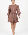 Fanm Mon Mel Dress on model featuring horse embroidery, voluminous long sleeves, a self-tie waist and ruffle mini hem