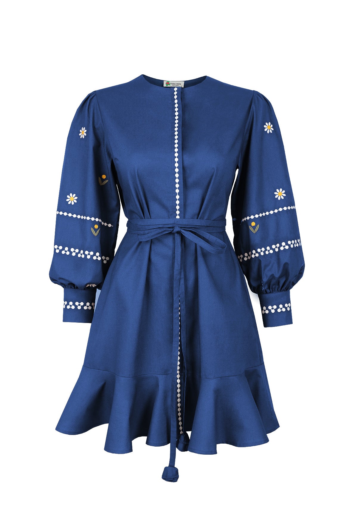 Fanm Mon Noen Dress in indigo blue with white daisy embroidery, blouson sleeves, braided tie waist and ruffled mini hem