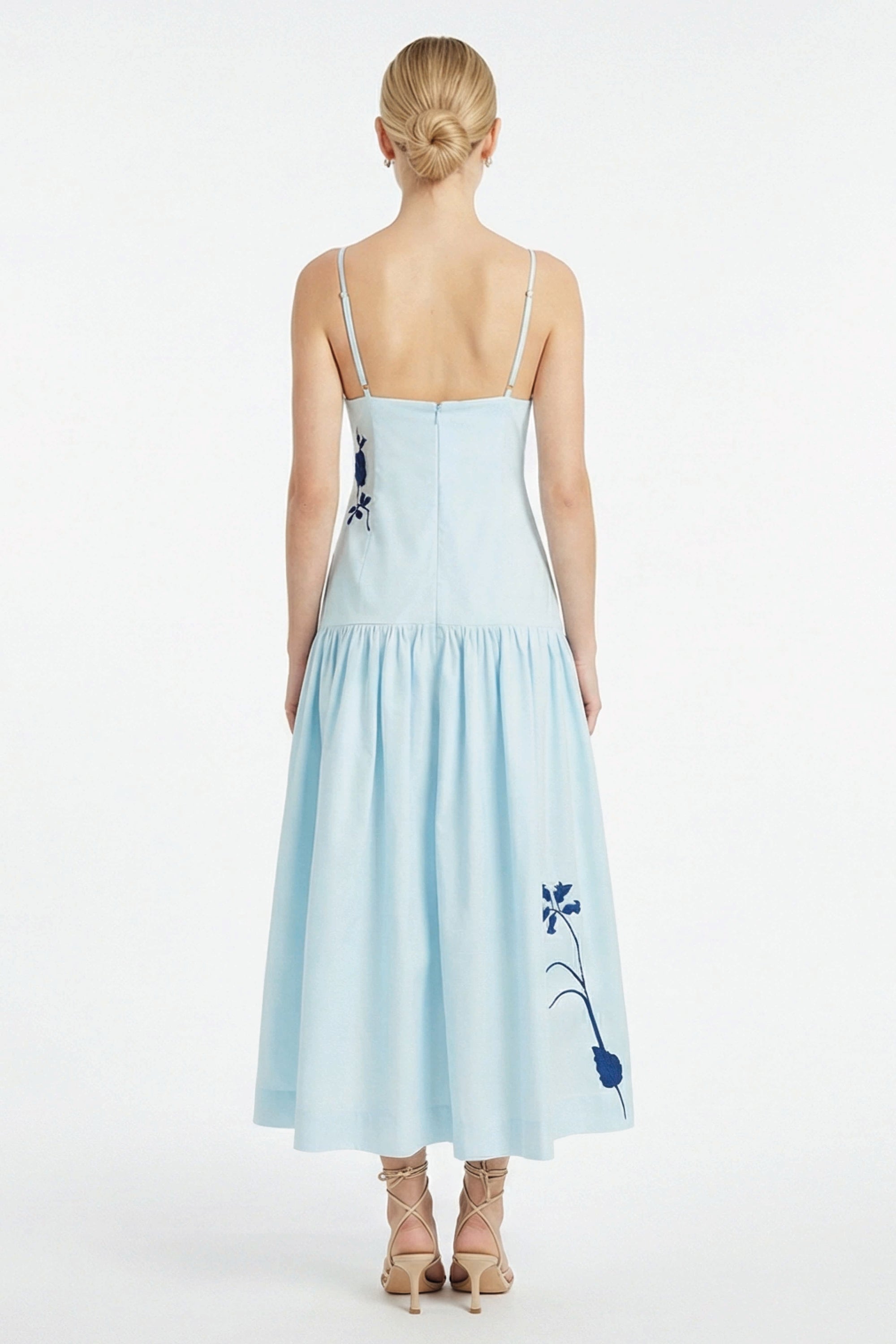 Back view of Fanm Mon Paola Dress with adjustable straps, fitted bodice, and flowing gathered midi skirt with floral embroidery.