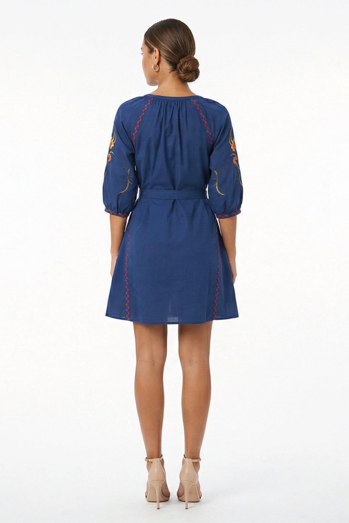 Back view of the Fanm Mon Pearl Dress featuring three-quarter balloon sleeves, a self-tie waist, floral embroidery, and contrast embroidered trim.
