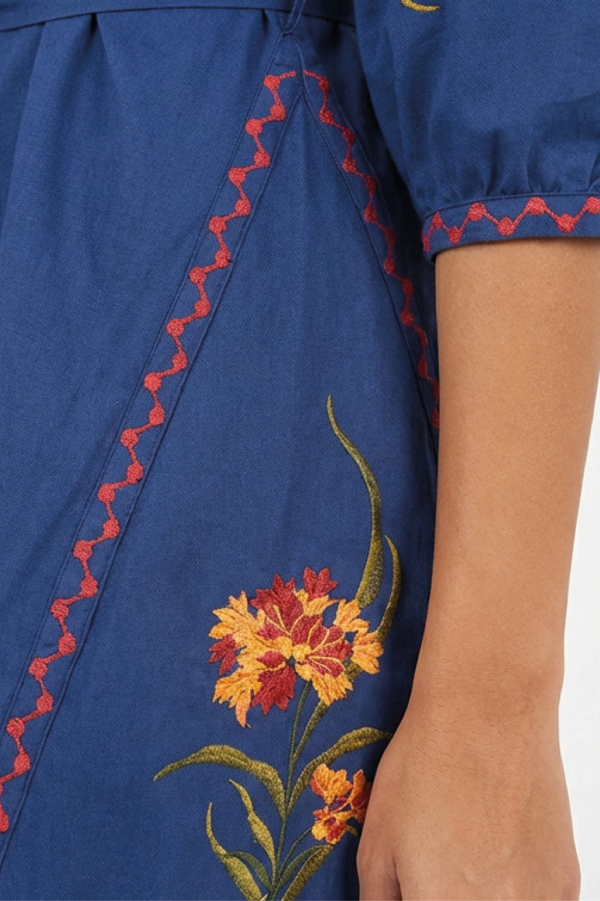 Close-up of the Fanm Mon Pearl Dress highlighting the floral embroidery, contrast embroidered trim, and three-quarter sleeve detailing.