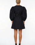 Back view of the Fanm Mon Pomender Dress showcasing the tailored bodice, voluminous puff sleeves,  and clean A-line mini silhouette.