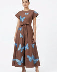 Fanm Mon Pulse Dress on model featuring scattered blue butterfly embroidery, short flutter sleeves, a self-tie waist and full midi skirt.