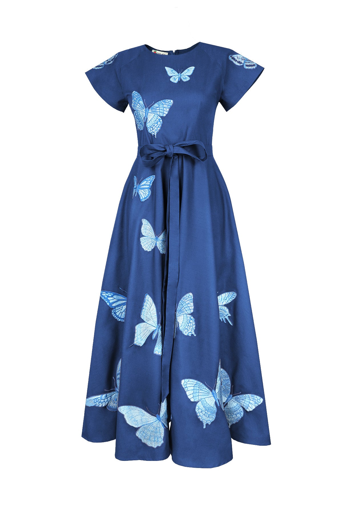 Fanm Mon Pulse Dress in indigo blue featuring tonal blue butterfly embroidery, short flutter sleeves, a self-tie waist and full midi skirt.