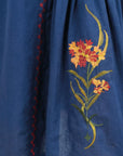 Close-up of the Fanm Mon Raya Dress highlighting intricate floral embroidery and contrast stitched detailing.