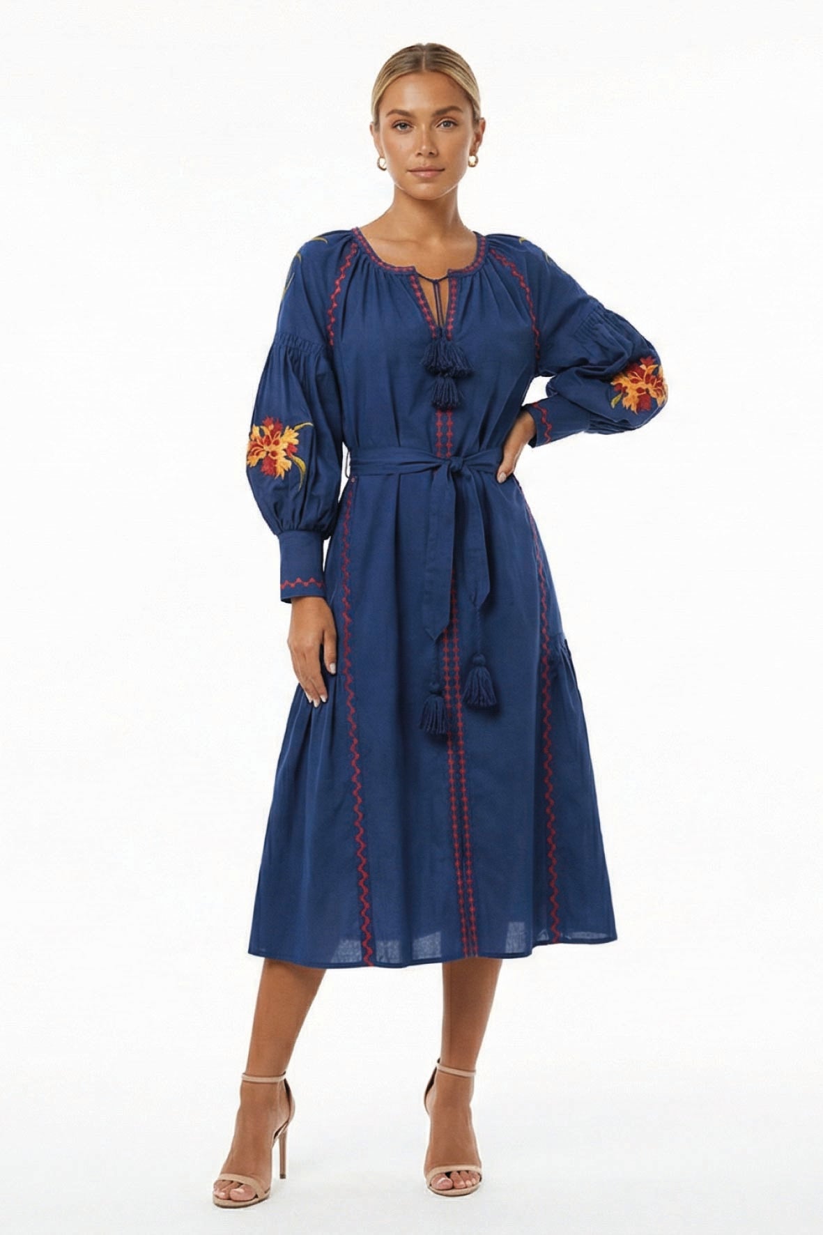 Model wearing the Fanm Mon Raya Dress featuring floral embroidered sleeves, tassel neckline, contrast stitching, and a self-tie waist belt.