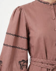 Close-up of the Fanm Mon Sakura Dress featuring black horse motifs, intricate embroidered sleeve bands, embroidered stand collar, and a braided waist belt.