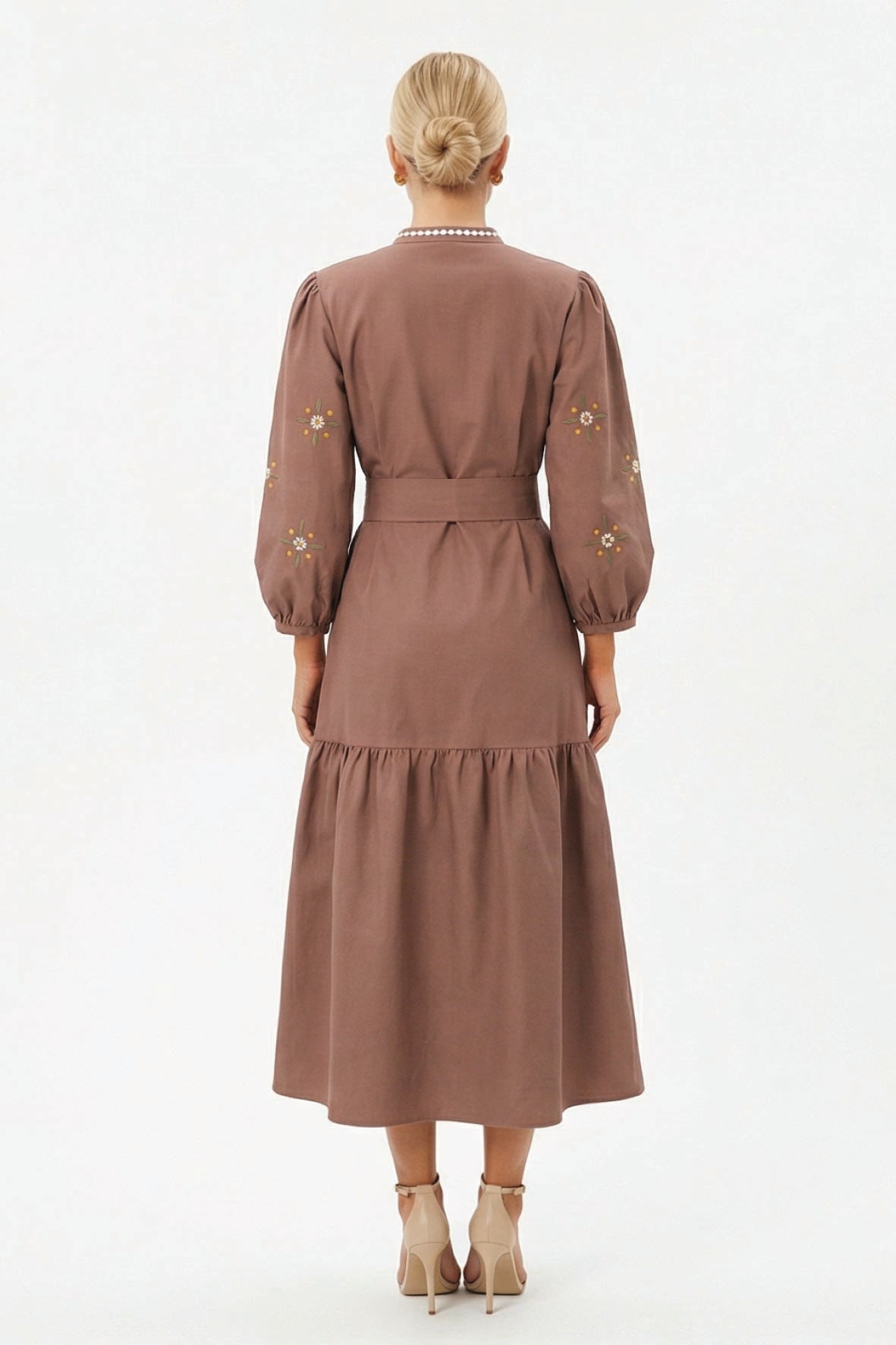 Back view of the Fanm Mon Samara Dress featuring floral embroidered sleeves, a belted waist, and gathered A-line midi skirt.