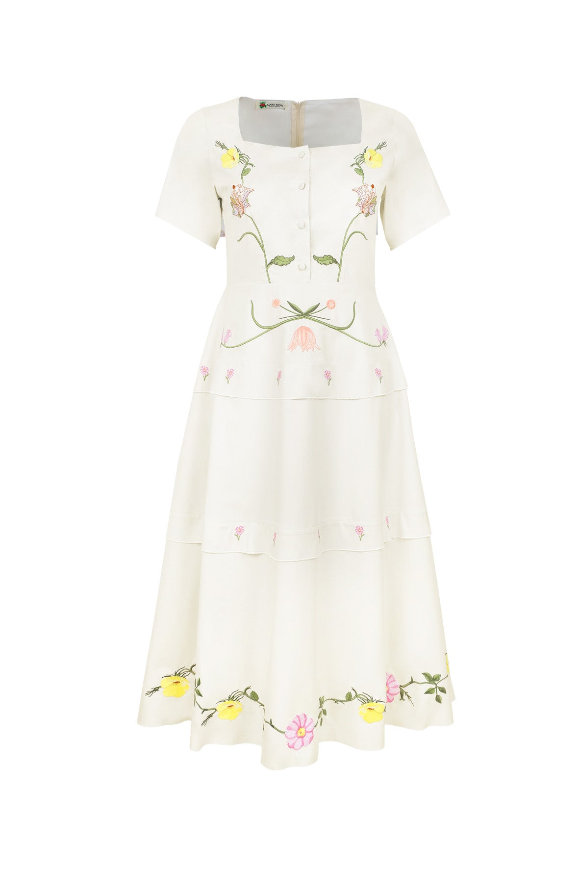 Fanm Mon Selma Dress featuring embroidered lilies, buttercups, cosmos, and botanical vines on a square-neck tiered midi silhouette with a peplum waist.