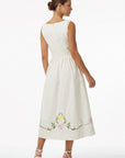 Back view of the Fanm Mon Veda Dress featuring a flowing A-line midi silhouette, gathered waist, concealed back zipper, and hand-embroidered floral vines along the hem.