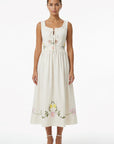 Model wearing the Fanm Mon Veda Dress featuring a softly gathered neckline with a self-tie detail, embroidered floral bodice, gathered waist, and flowing midi skirt.