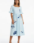 Fanm Mon Yaprak Dress featuring hydrangea embroidery, square neckline, flared sleeves, and flowing midi silhouette.
