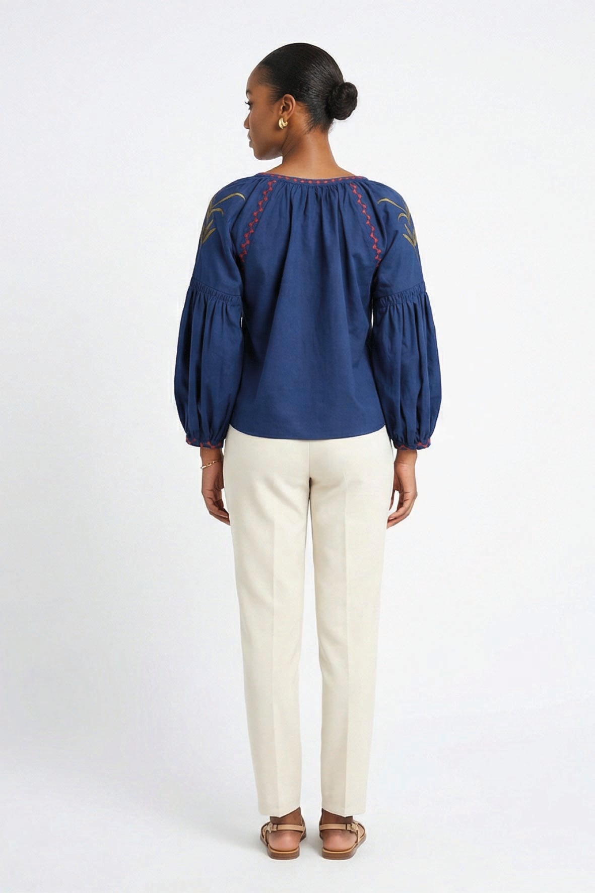 Back view of model wearing Fanm Mon Akik Top showing gathered neckline and embroidered shoulder details