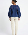 Back view of model wearing Fanm Mon Akik Top showing gathered neckline and embroidered shoulder details