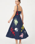 Back view of the Fanm Mon Atike Dress with wide straps, fitted bodice and multicolored floral embroidery.