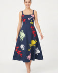 Model wearing the Fanm Mon Atike Dress with multicolored floral embroidery, fitted square-neck bodice and full midi skirt.