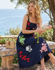 Model wearing the Fanm Mon Atike floral embroidered midi dress with a fitted bodice and full skirt.
