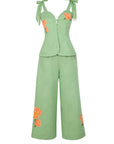 Fanm Mon Collette Set in green tea featuring a fitted button-front peplum top, tie shoulder straps, and wide-leg trousers with orange and yellow floral embroidery