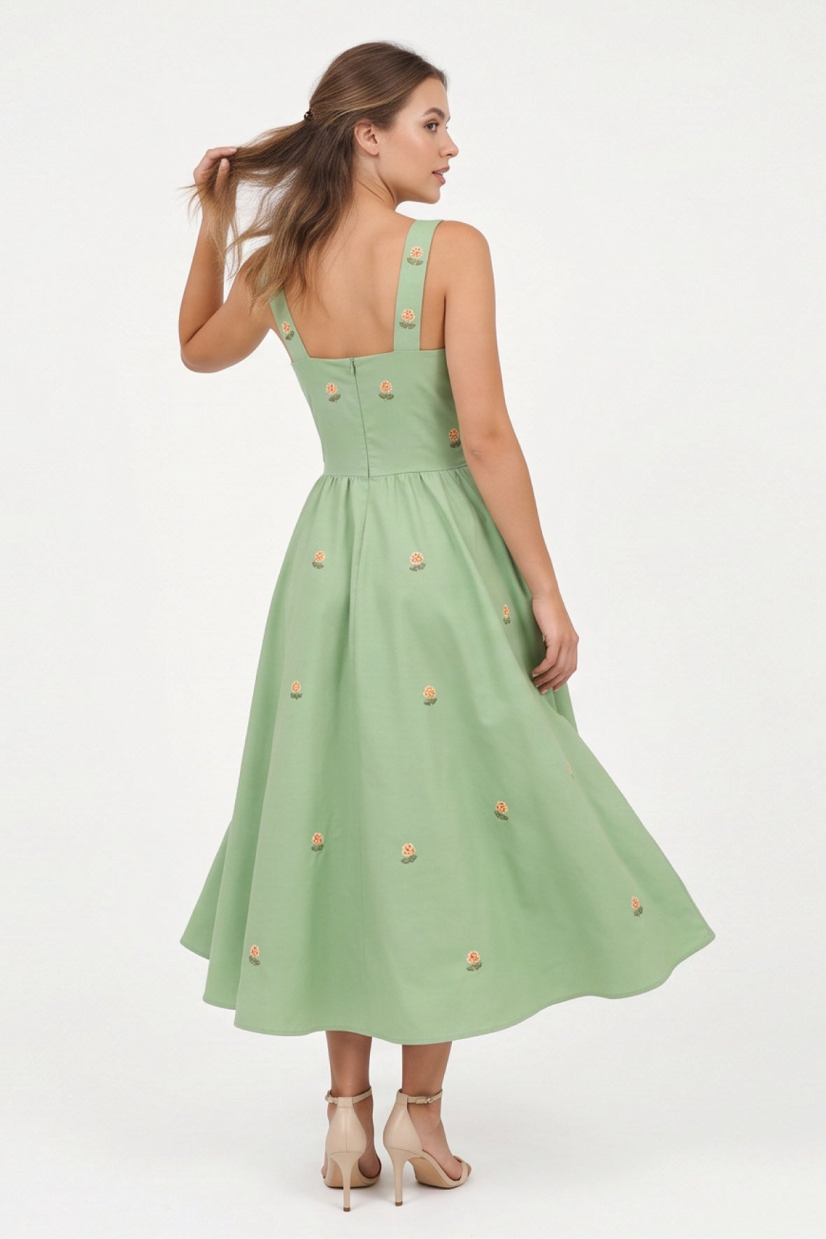 Back view of the Fanm Mon Dagana Dress featuring wide straps, delicate floral embroidery and a full gathered midi skirt.