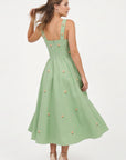 Back view of the Fanm Mon Dagana Dress featuring wide straps, delicate floral embroidery and a full gathered midi skirt.
