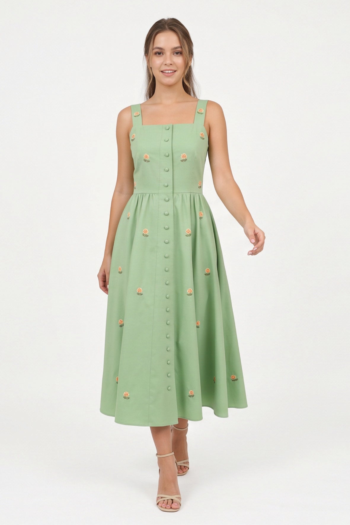 Model wearing the Fanm Mon Dagana Dress with a square neckline, floral embroidery and tonal covered buttons.