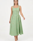 Model wearing the Fanm Mon Dagana Dress with a square neckline, floral embroidery and tonal covered buttons.