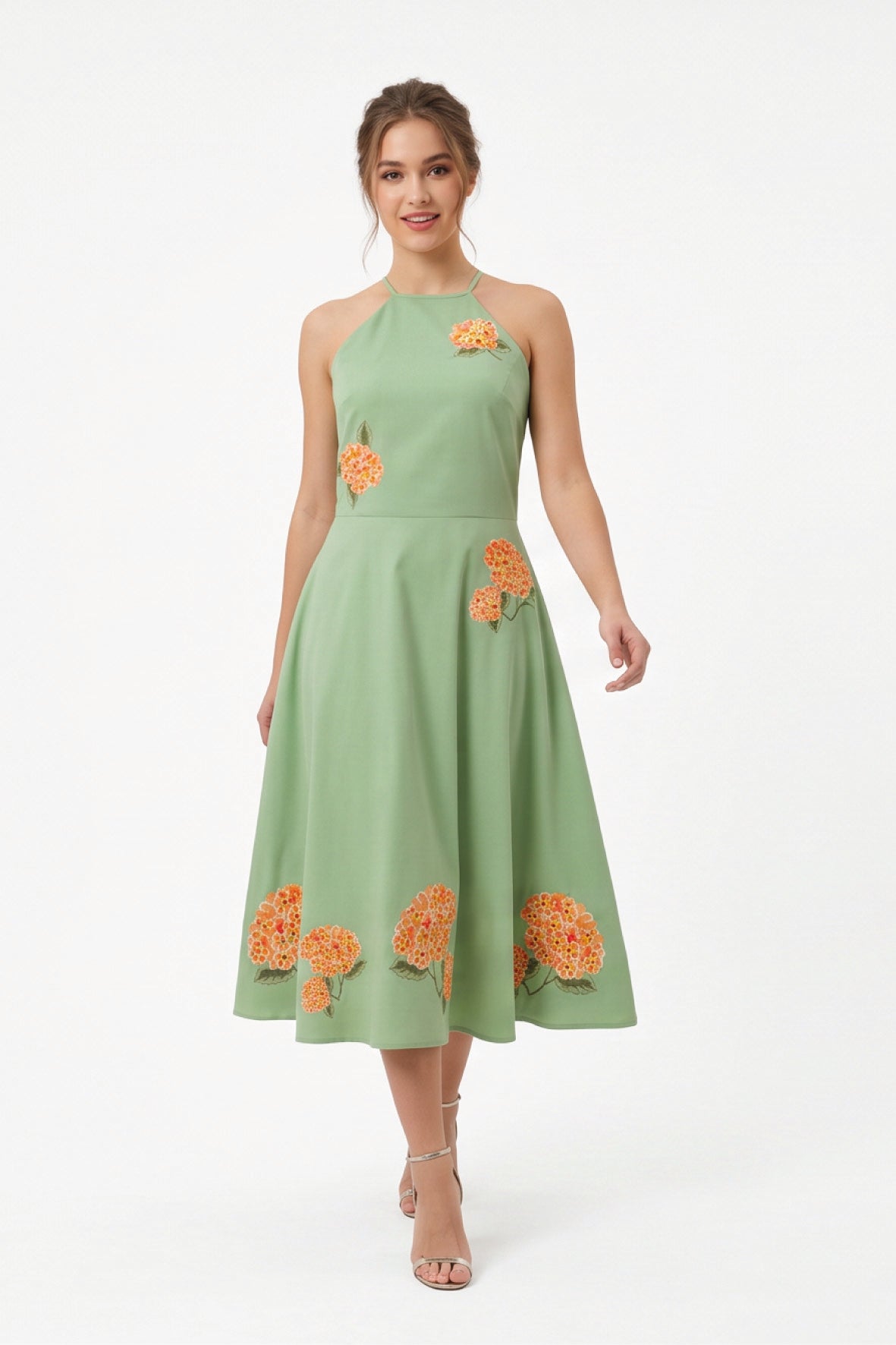 Model wearing the Fanm Mon Fora Dress with a halterneck bodice, hydrangea embroidery and a full A-line midi skirt.