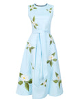 Fanm Mon Gemimi Dress in light lagoon featuring a fitted sleeveless bodice, coordinating tie belt, and scattered white floral embroidery across the flowing A-line midi skirt.