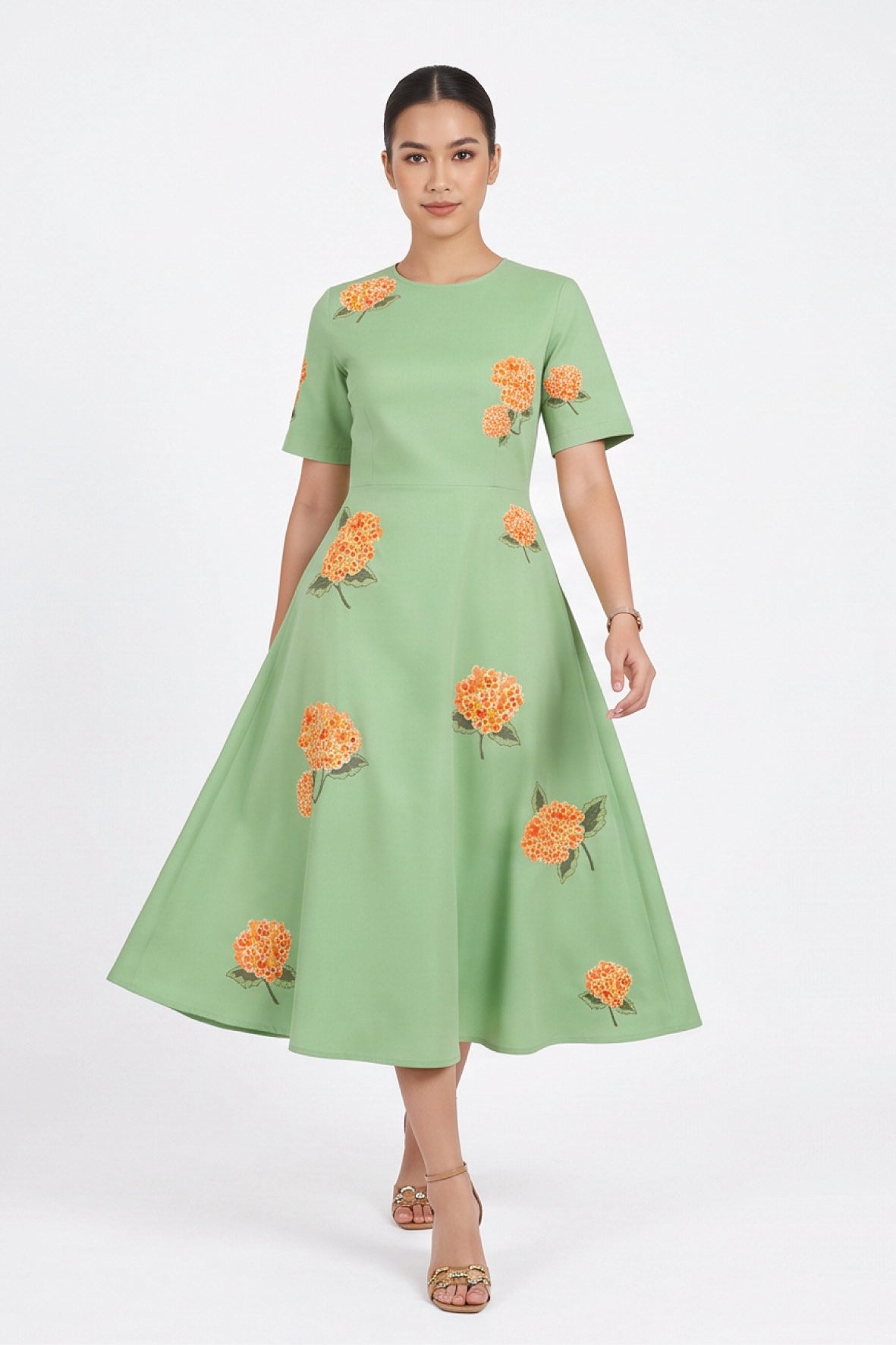 Model wearing the Fanm Mon Gemlik Dress with hydrangea embroidery, short sleeves and a full A-line midi skirt.
