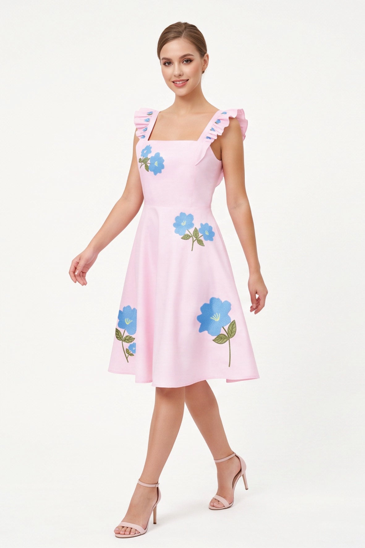 Model wearing the Fanm Mon Hype Dress with blue floral embroidery, square neckline and embroidered ruffle straps.