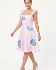 Model wearing the Fanm Mon Hype Dress with blue floral embroidery, square neckline and embroidered ruffle straps.