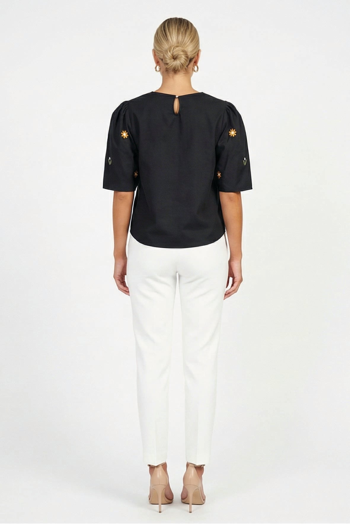 Back view of model wearing Fanm Mon Kehribar Top in black with short sleeves and keyhole neckline