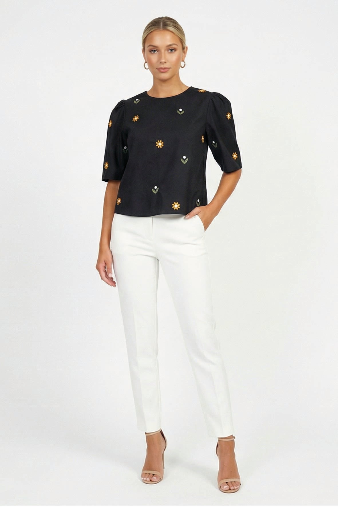 Model wearing Fanm Mon Kehribar Top in black with scattered floral embroidery and short puff sleeves
