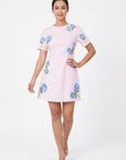 Model wearing the Fanm Mon Kore Dress with vivid blue floral embroidery, short sleeves and an A-line mini silhouette.