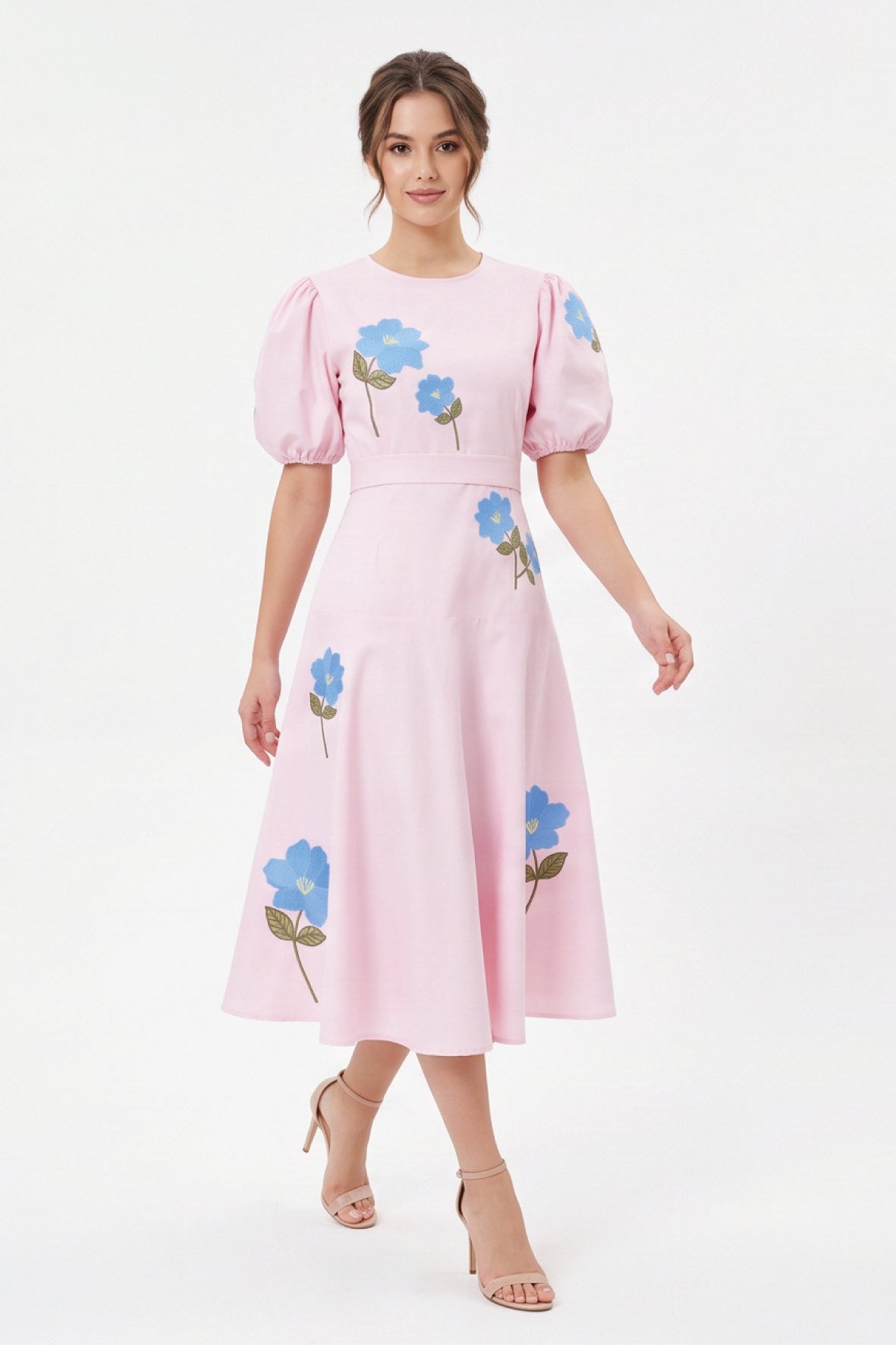 Model wearing the Fanm Mon Lare Dress with blue floral embroidery, puff sleeves and a defined A-line midi silhouette.
