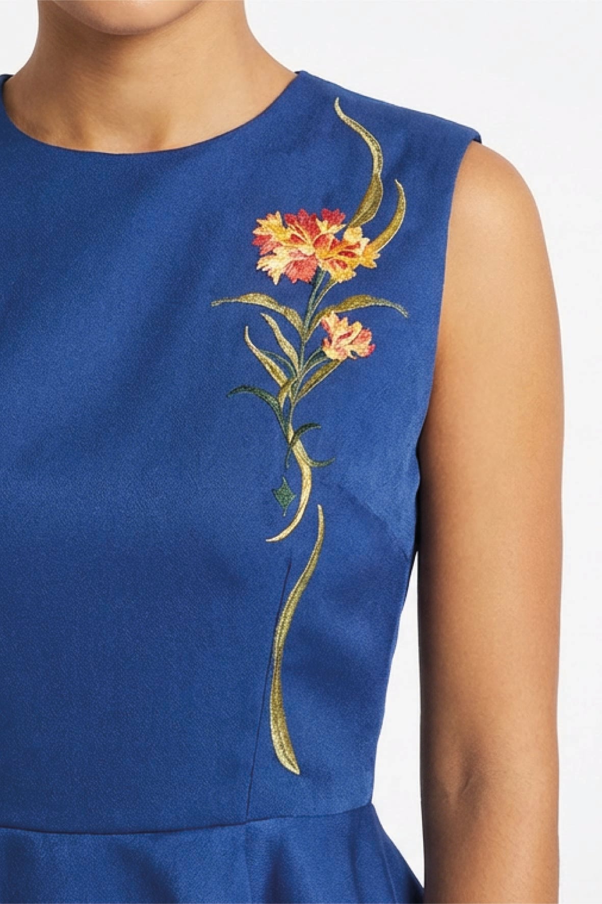 Close-up of floral embroidery on Fanm Mon Marena peplum top in deep blue